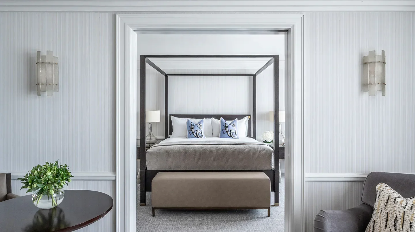 Elegant bedroom at The Westbury Hotel in Dublin, featuring a four-poster bed.