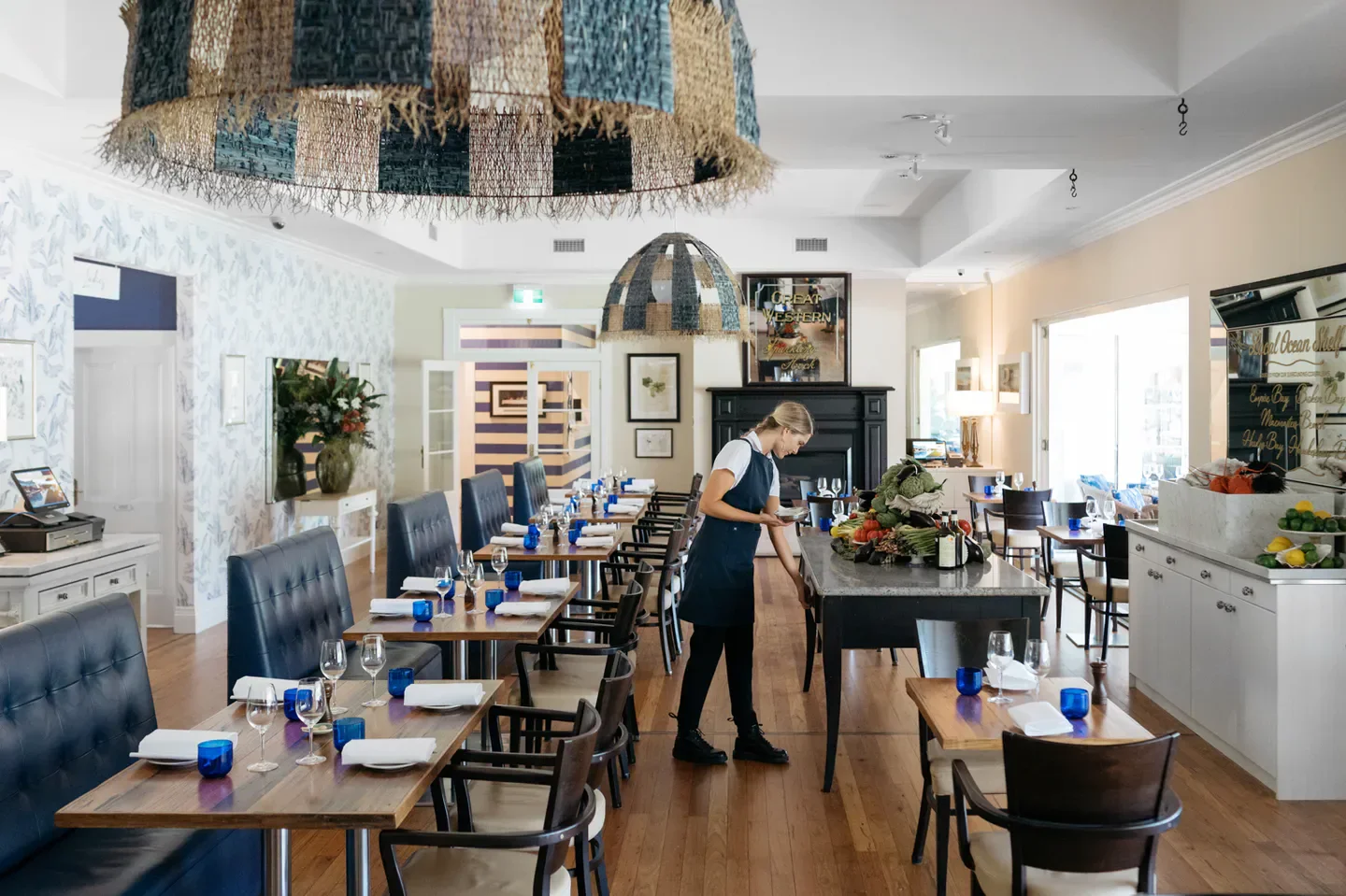 Interior of The Wild Flower Bar & Dining on the Central Coast with server preparing.