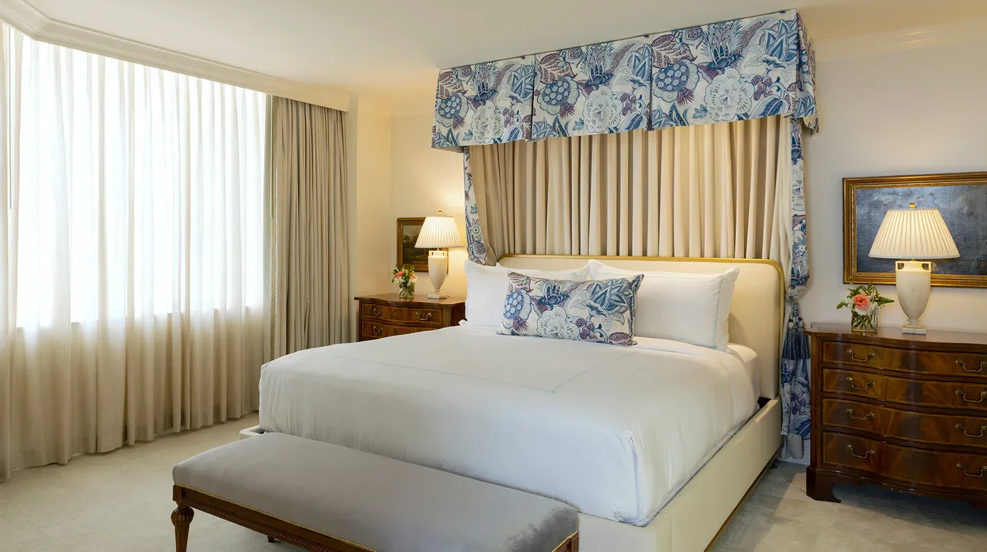 Elegant bedroom at The Windsor Court hotel in New Orleans with canopy bed.