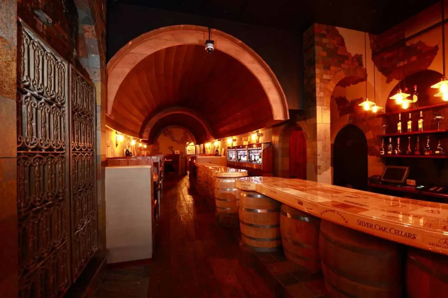 Interior view of The Wine Room in Edmonton, featuring rustic bar and wine barrels.
