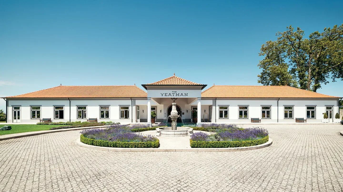Exterior view of The Yeatman Hotel in Porto, Portugal with fountain and landscaping.
