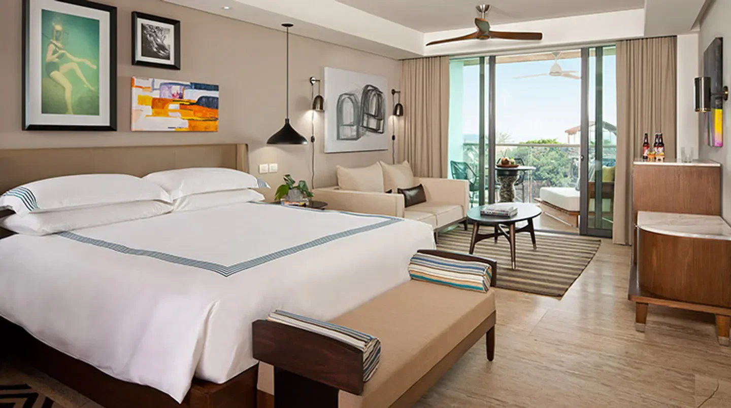 Stylish hotel room at Thompson Playa del Carmen Main House in Riviera Maya with a balcony.