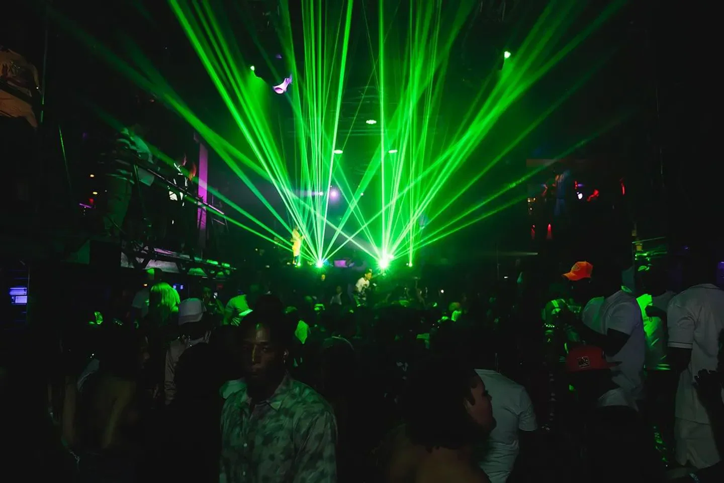 Tier nightclub in Orlando with green laser lights and a crowd of people