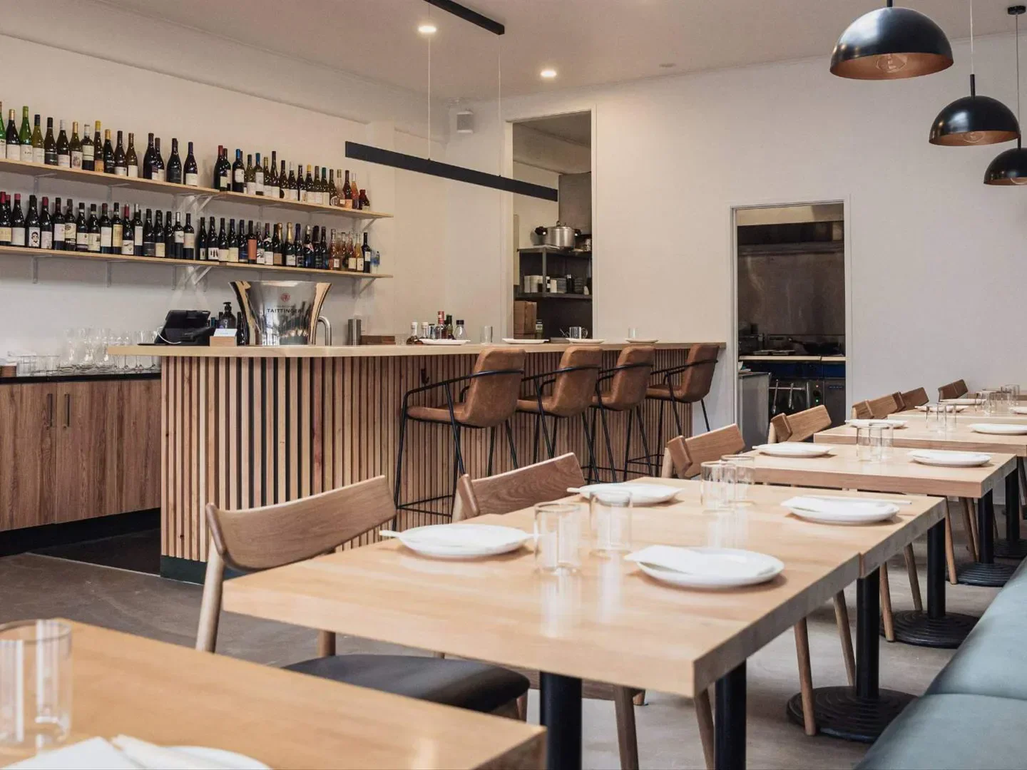 Interior of Tokki restaurant in Auckland, with tables set for dining and a stylish bar.
