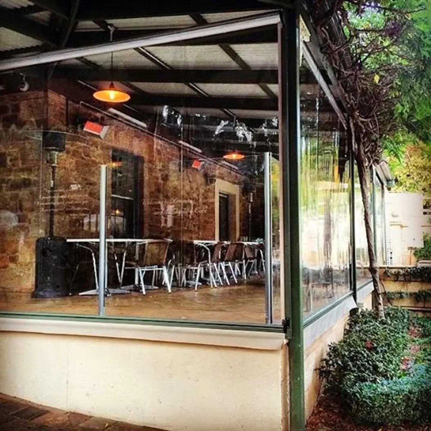 Topiary restaurant in Adelaide, showing outdoor dining area with a view of greenery.
