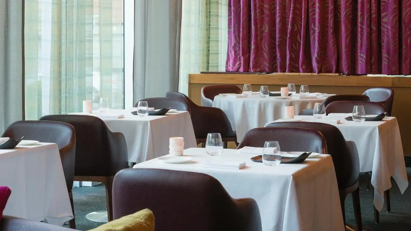 Interior of Toqué! restaurant in Montreal, featuring elegant tables and ambiance.