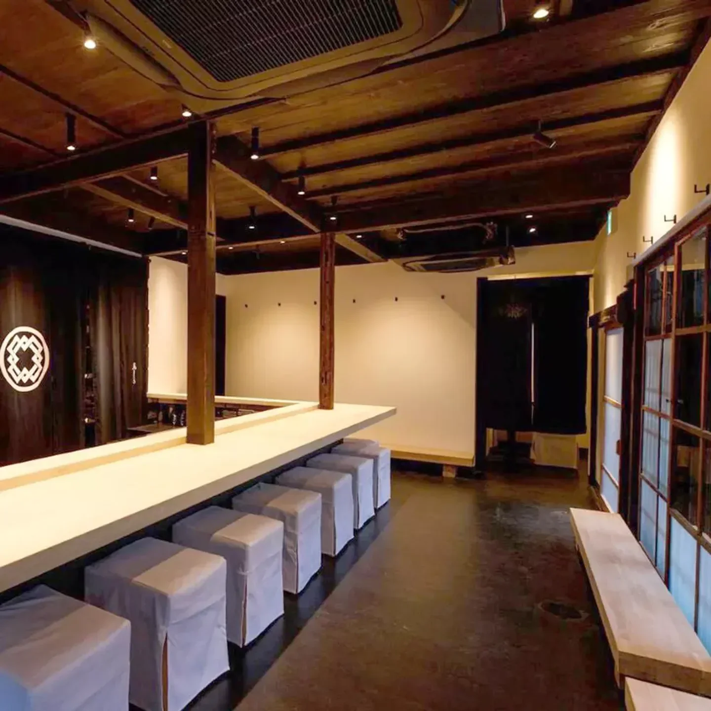 Interior of Torisaki restaurant in Kyoto, featuring wooden beams and stylish seating.