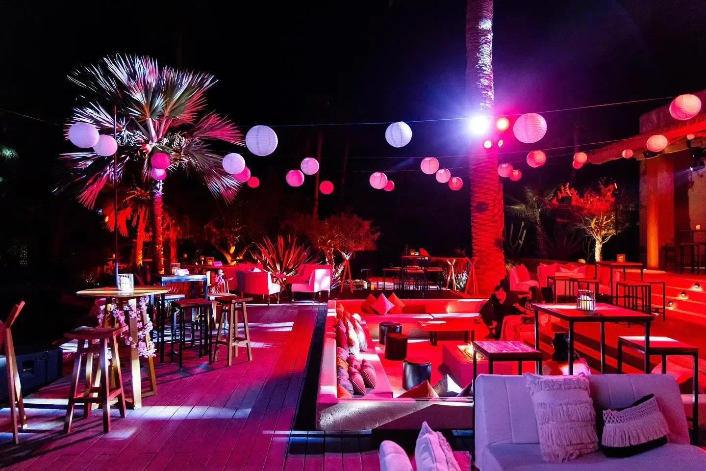 Toro Latin Kitchen in Los Cabos, a beautifully lit outdoor space with lanterns and palm trees