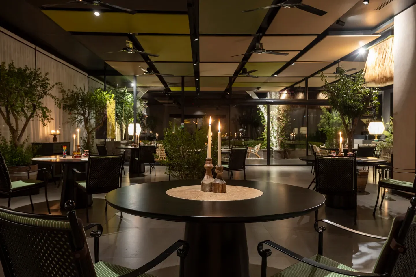 Candlelit dining at Tre Olivi restaurant in Campania, with an elegant, modern interior.