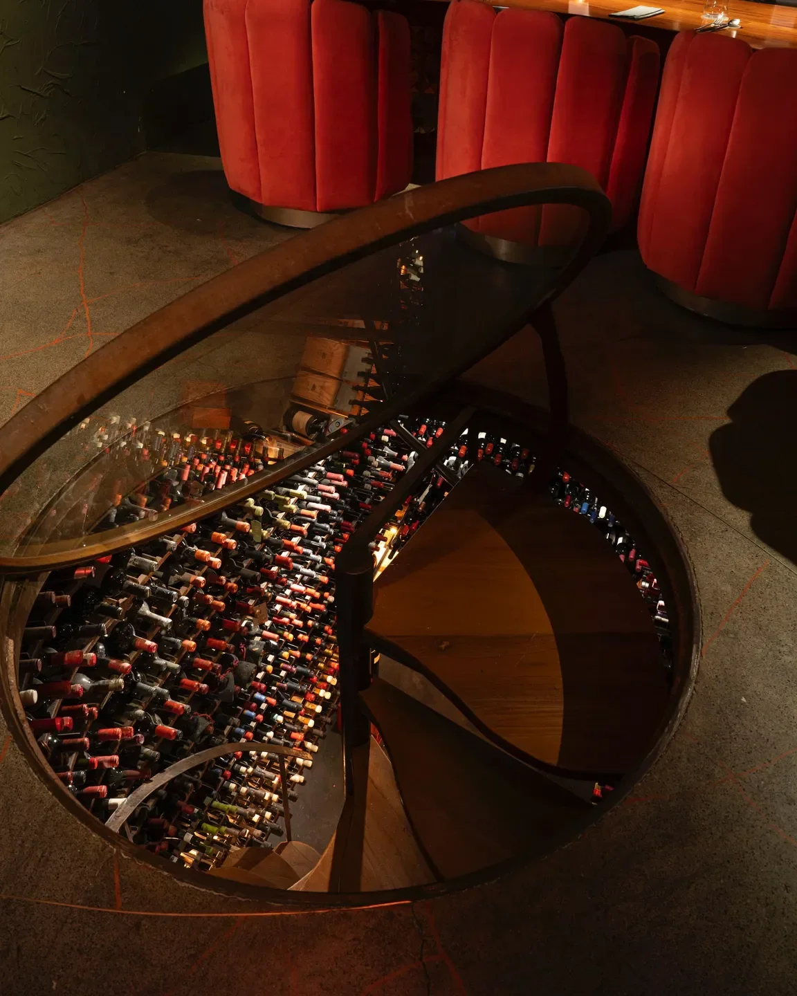 Spiral wine cellar at TRESCHA in Buenos Aires with access from the dining area.