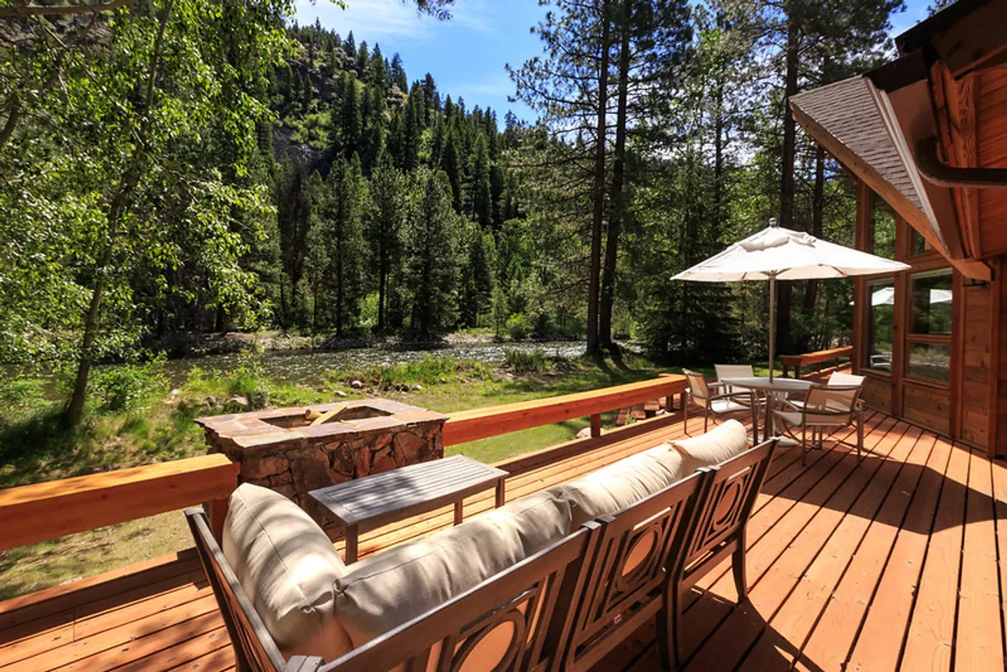 Outdoor patio at Triple Creek Ranch in Southern Montana, overlooking river and forest