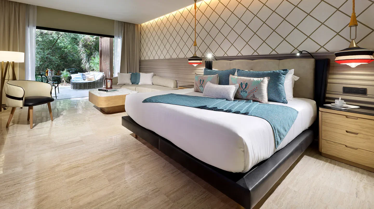 Luxury bedroom at TRS Yucatan Hotel in Riviera Maya with patio access and stylish decor.