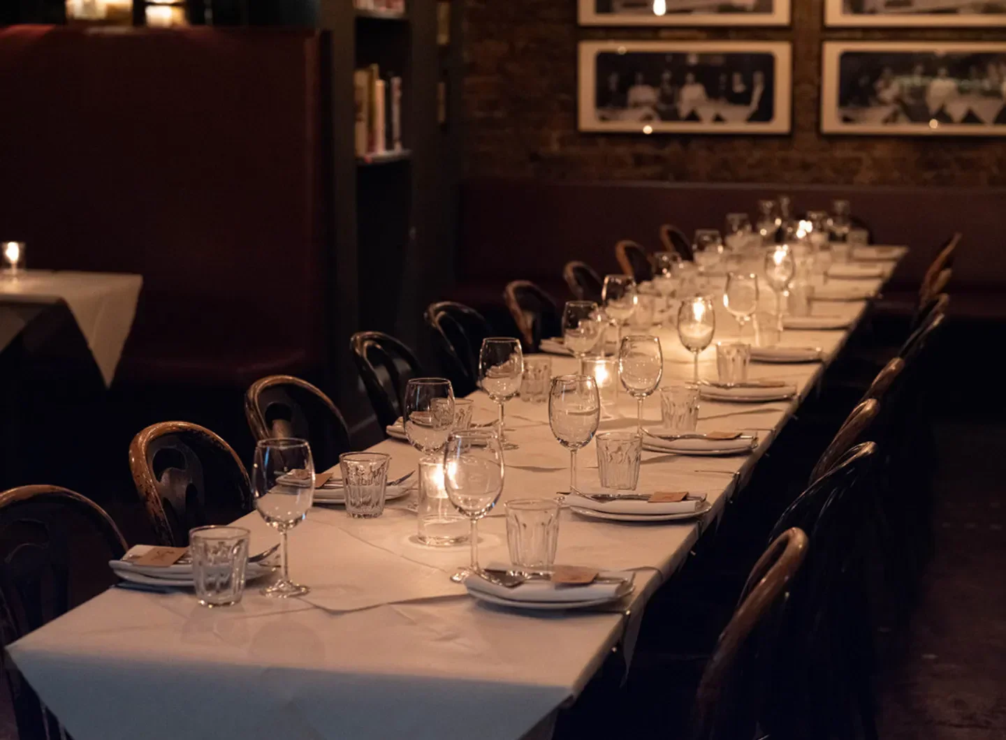 Elegant dining table set at Trullo restaurant in London, with candles and wine glasses.