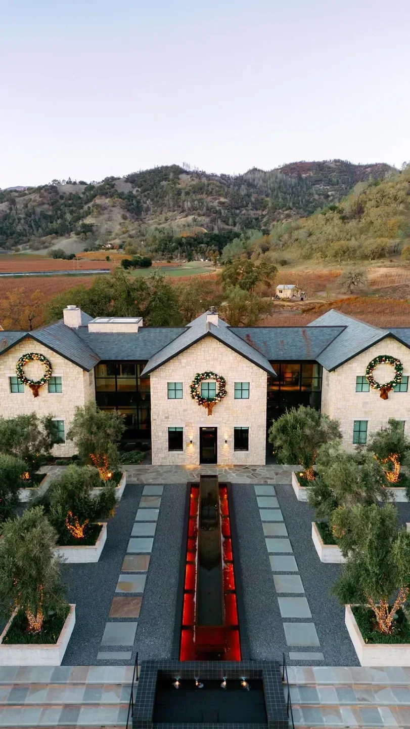Exterior view of TRUSS restaurant in Napa Valley, with wreaths and holiday lights.