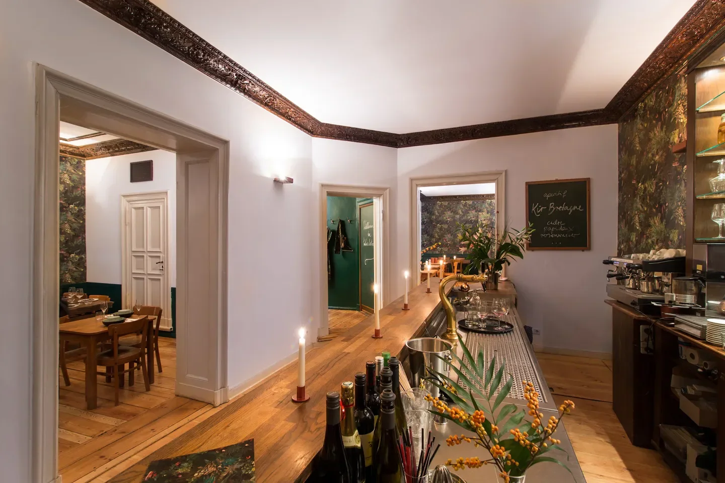 Interior of tulus lotrek restaurant in Berlin, with wooden bar and candlelit ambiance