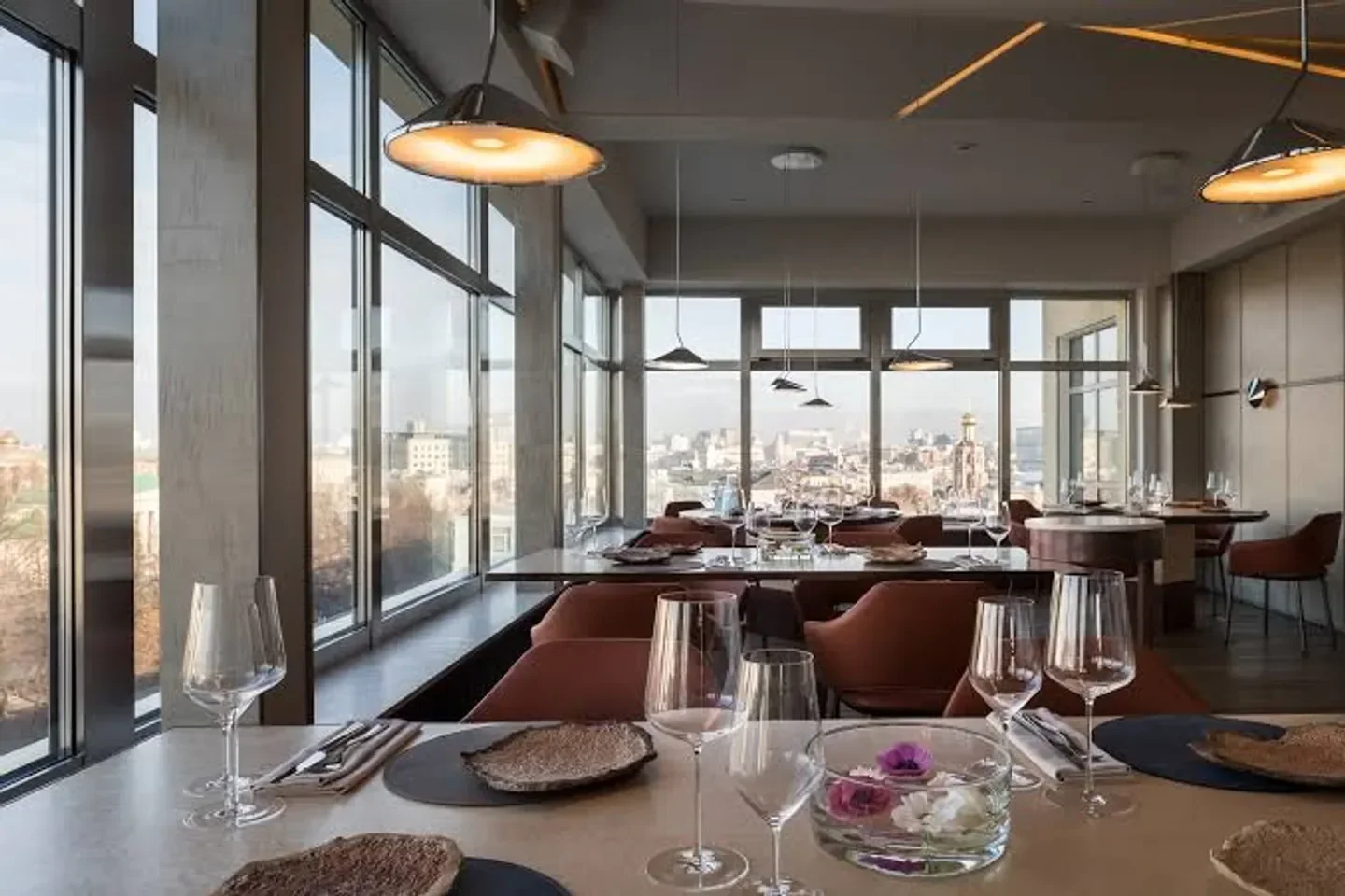 Stylish interior of Twins Garden restaurant in Moscow with city views and elegant decor.