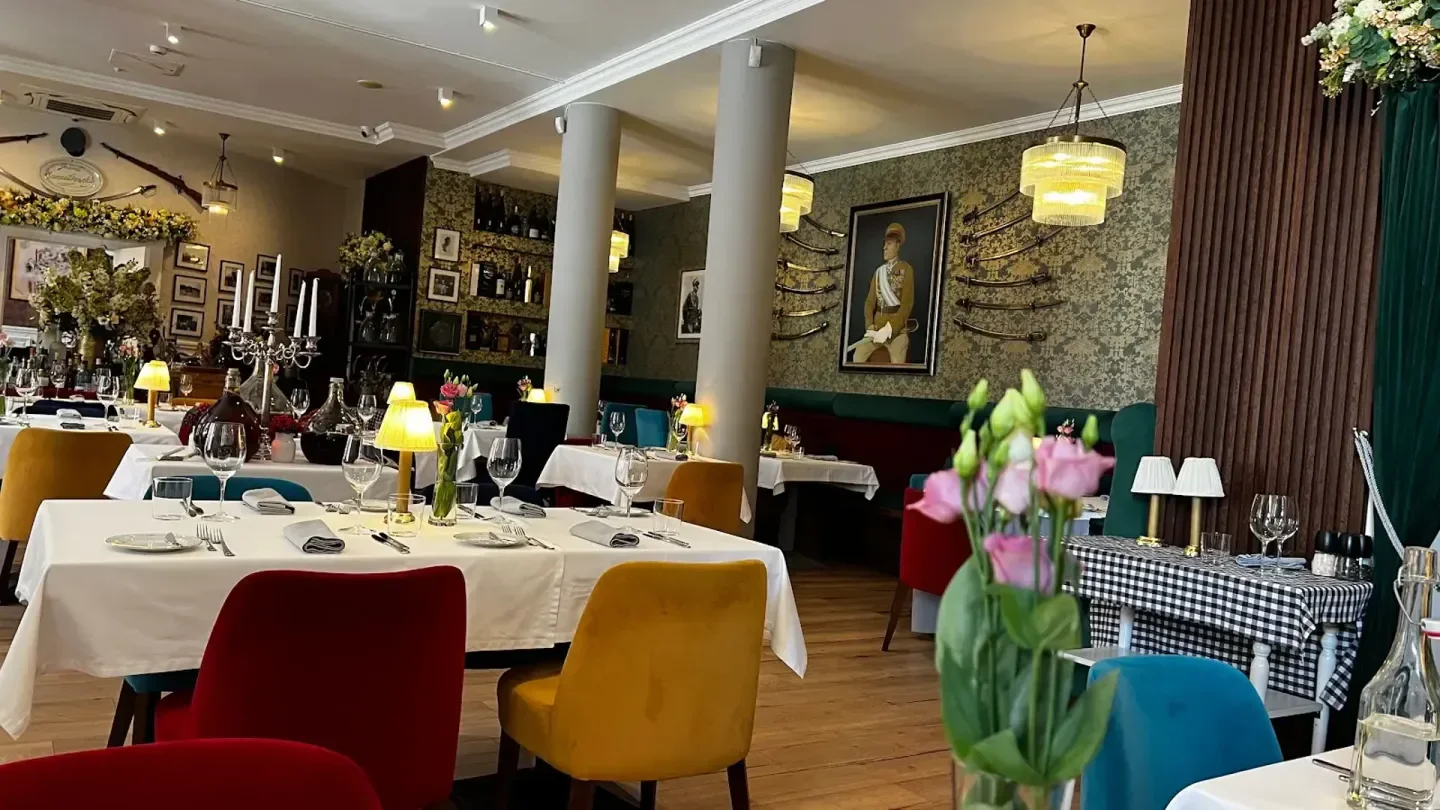 Elegant dining at U Wieniawy restaurant in Warsaw, with colorful chairs and tables.