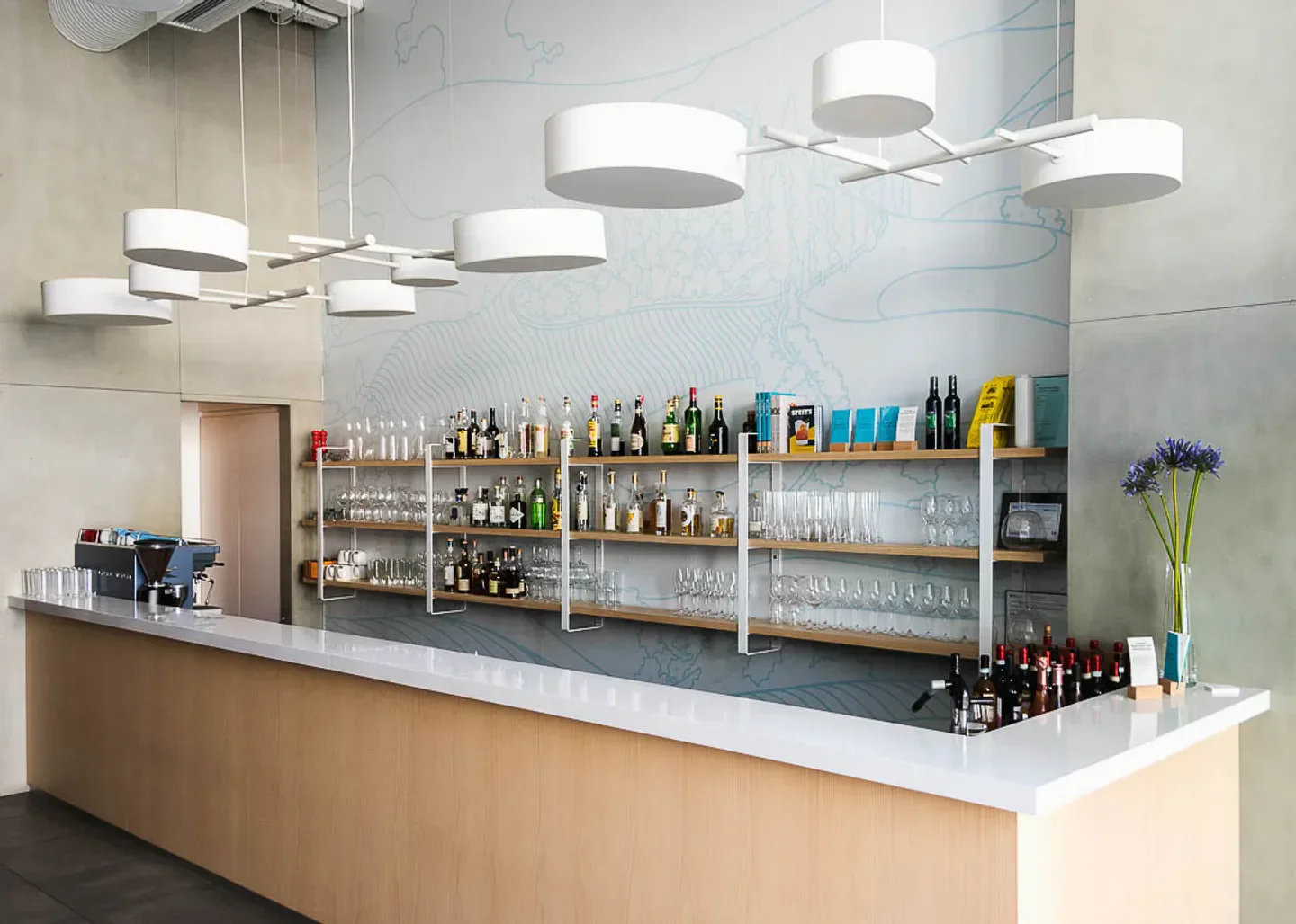 Modern interior of Uccellino restaurant in Edmonton, featuring a stylish bar with drinks.