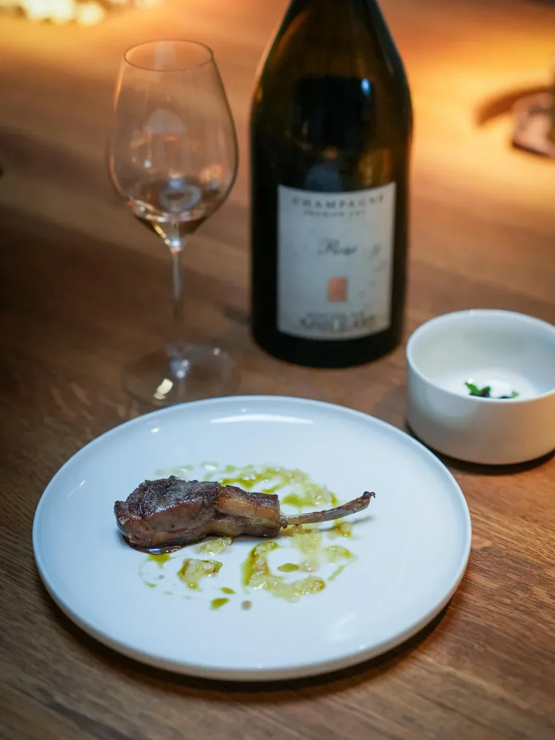 Delicious lamb dish and champagne at Uliassi restaurant in Marche, Italy.