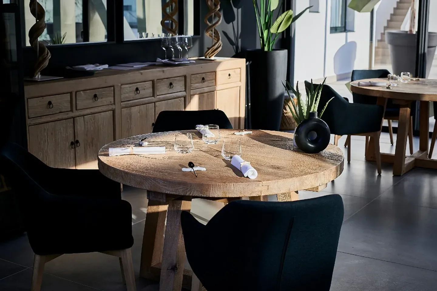 Restaurant interior at Unic Ibiza, featuring a wooden table set for dinner.