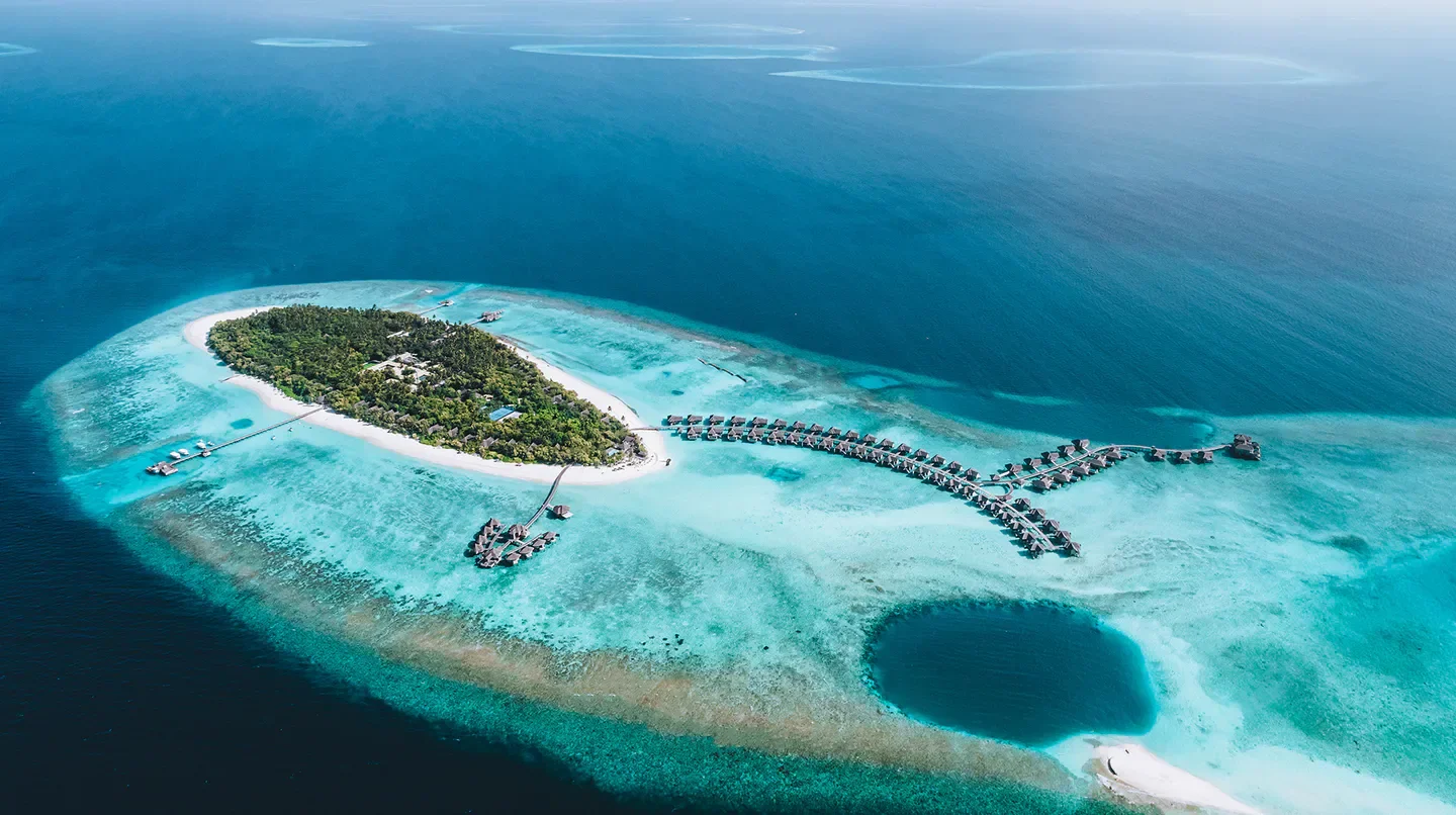 Aerial view of Vakkaru Maldives, a tropical paradise in the Maldives, surrounded by turquoise waters.