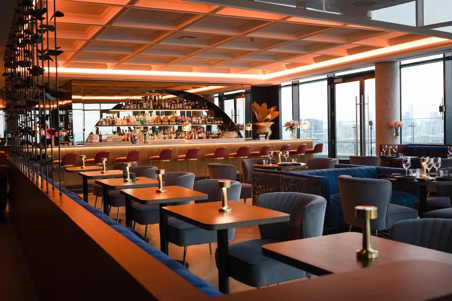 Interior of Valerie restaurant in Toronto. Bar and tables with city views.