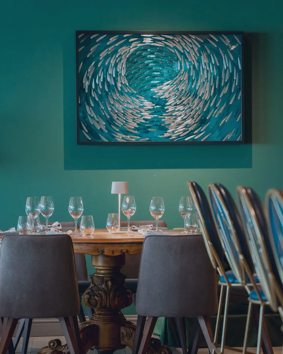 Elegant dining at Varoulko Seaside in Athens, featuring art and stylish decor.