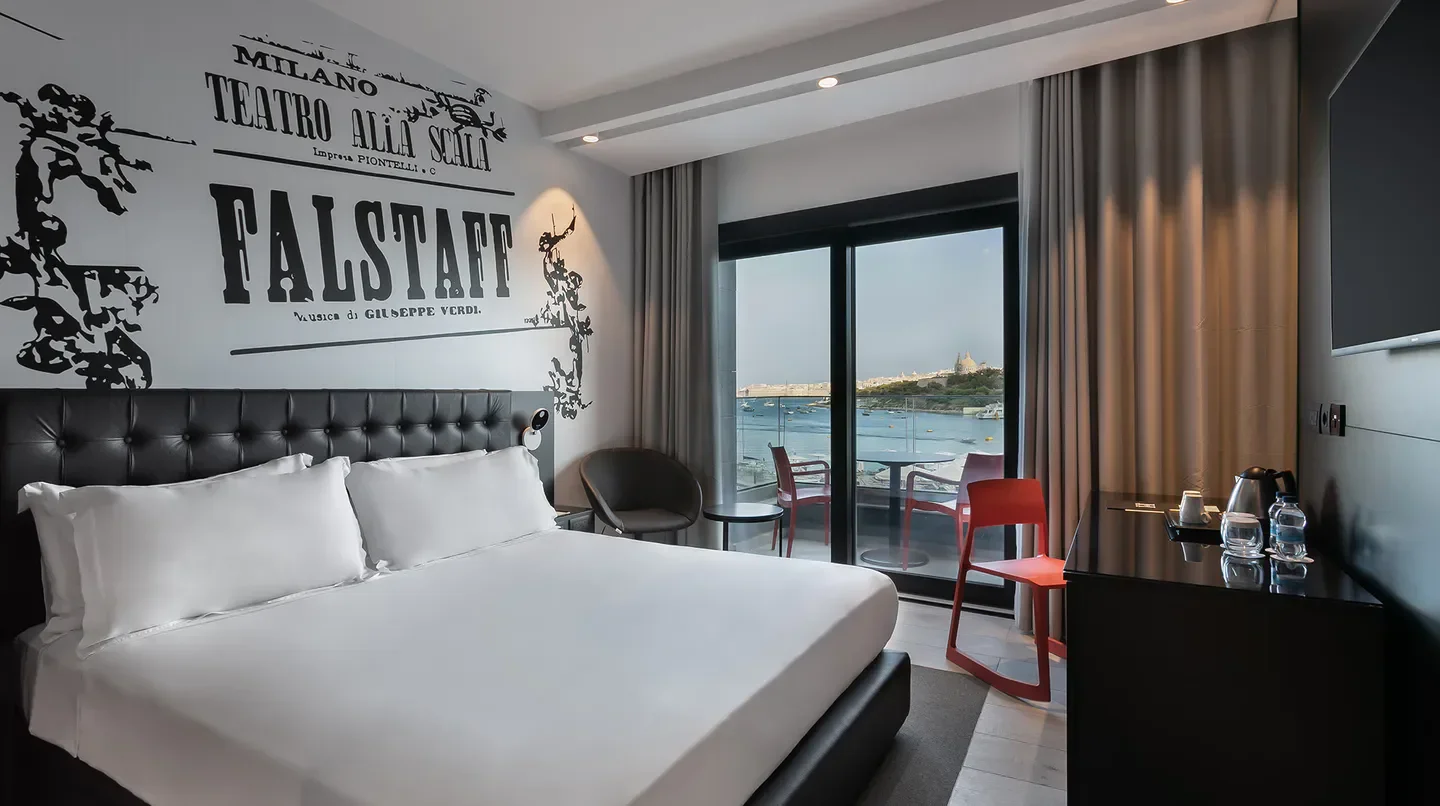 Stylish hotel room at Verdi Gzira Promenade in Malta, with a balcony view.