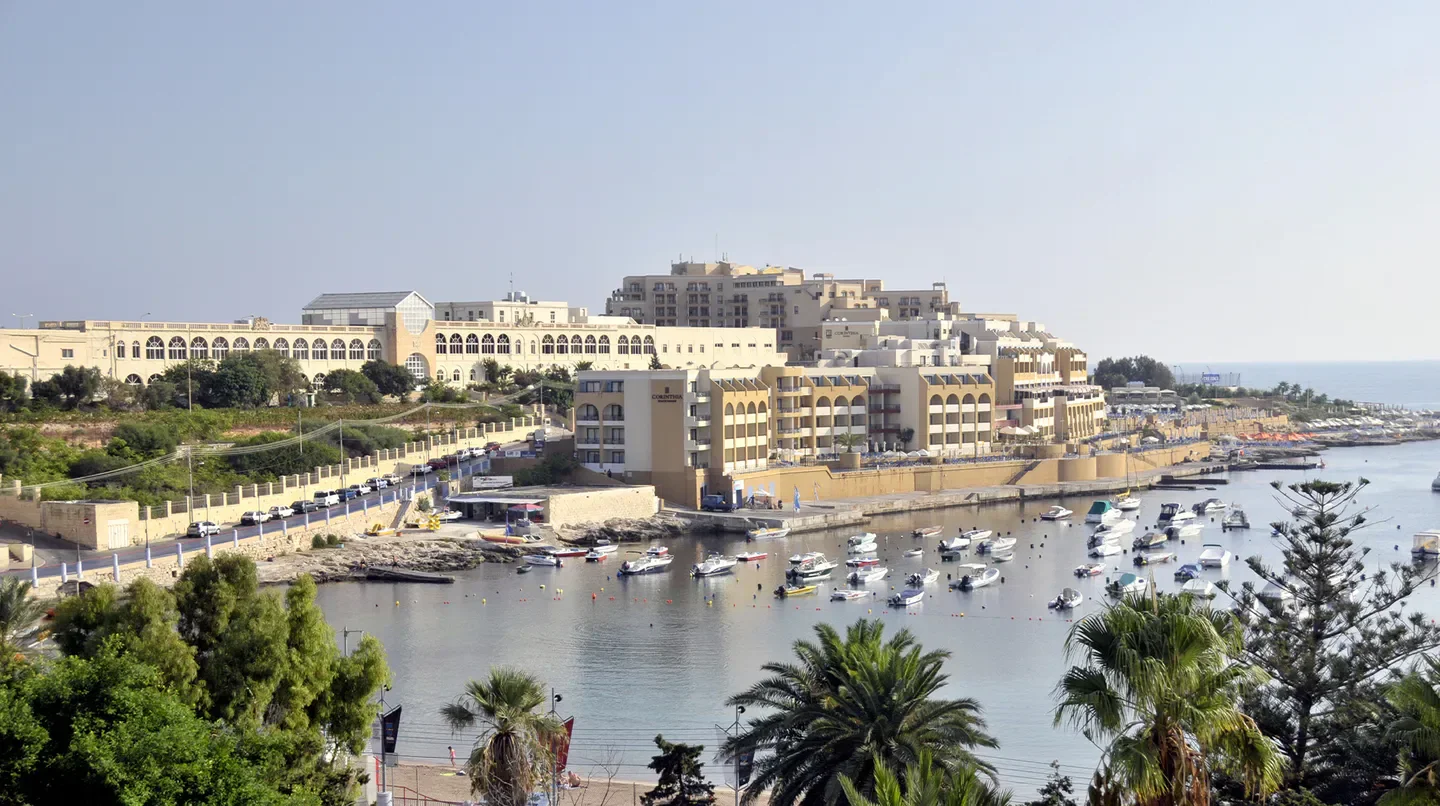 Boats docked at Verdi St. George's Bay Marina in Malta, hotel views and bay