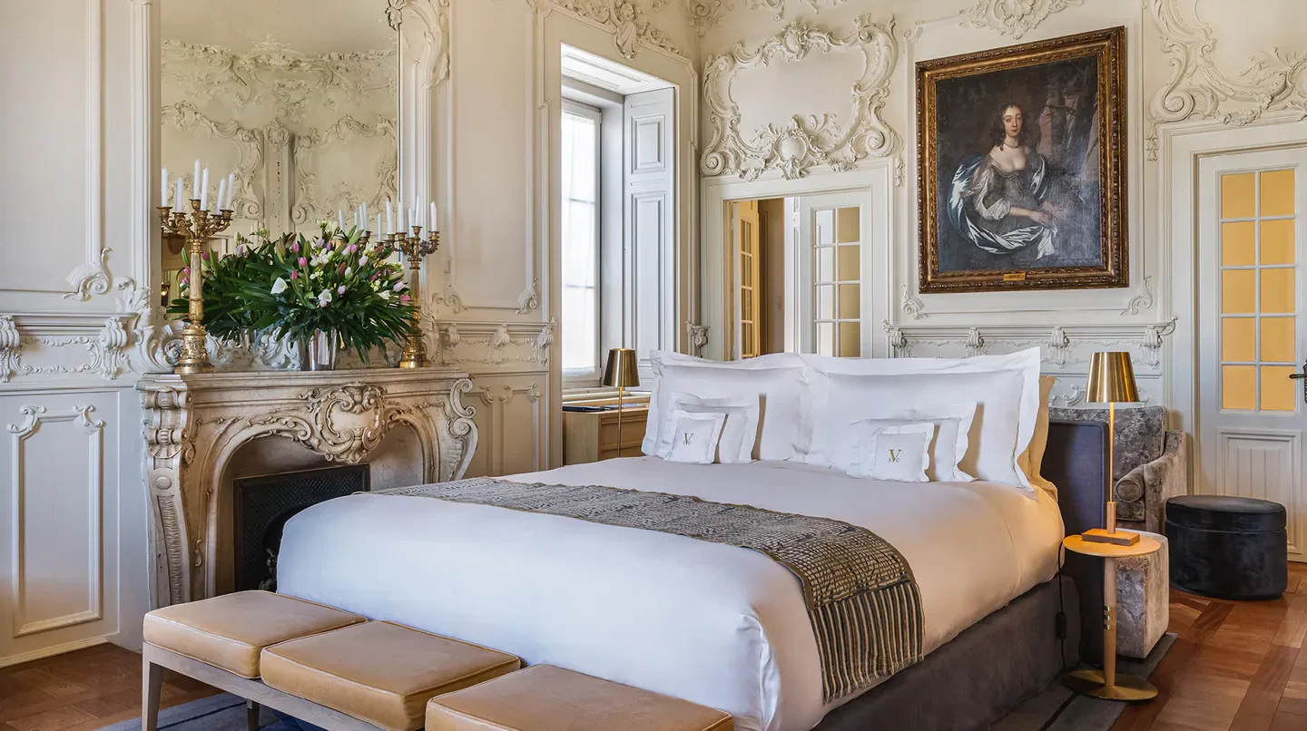 Elegant bedroom at Verride Palácio de Santa Catarina, Lisbon, featuring antique decor.