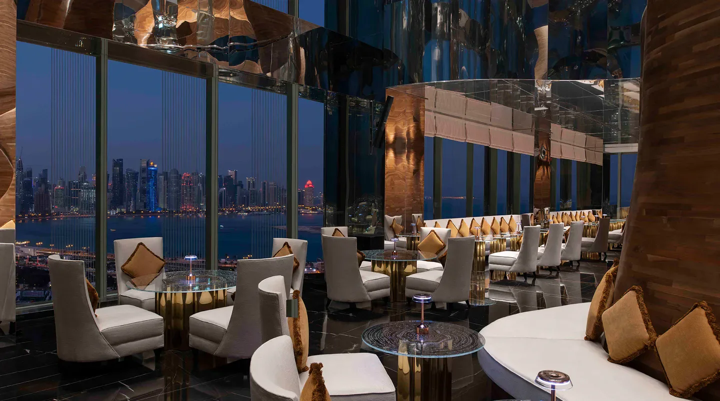 Interior of Vertigo restaurant in Doha, with stunning city views at dusk.