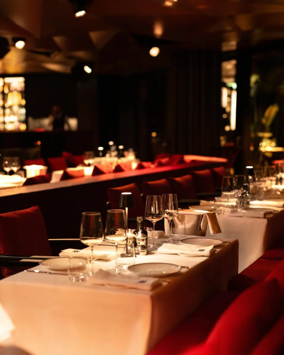 Vesta Portofino restaurant interior on the Italian Riviera with elegant table settings and red seating.