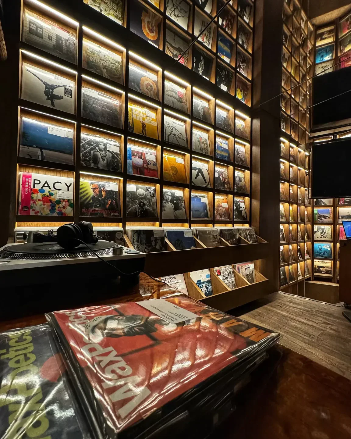 Vezené Athens restaurant with a vinyl record wall and turntable setup.
