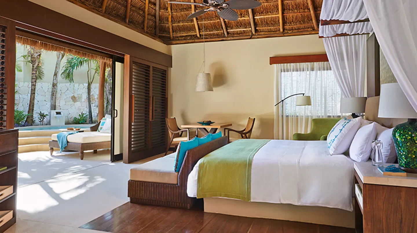 Luxury bedroom at Viceroy Riviera Maya in Playa del Carmen with pool view and stylish decor.