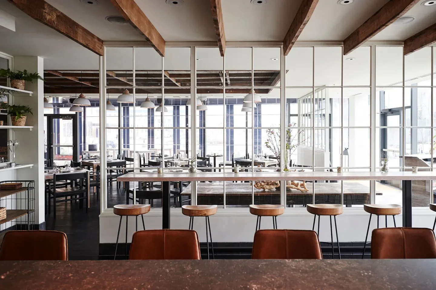 Interior view of Vicia restaurant in St. Louis, featuring bar stools and dining area.
