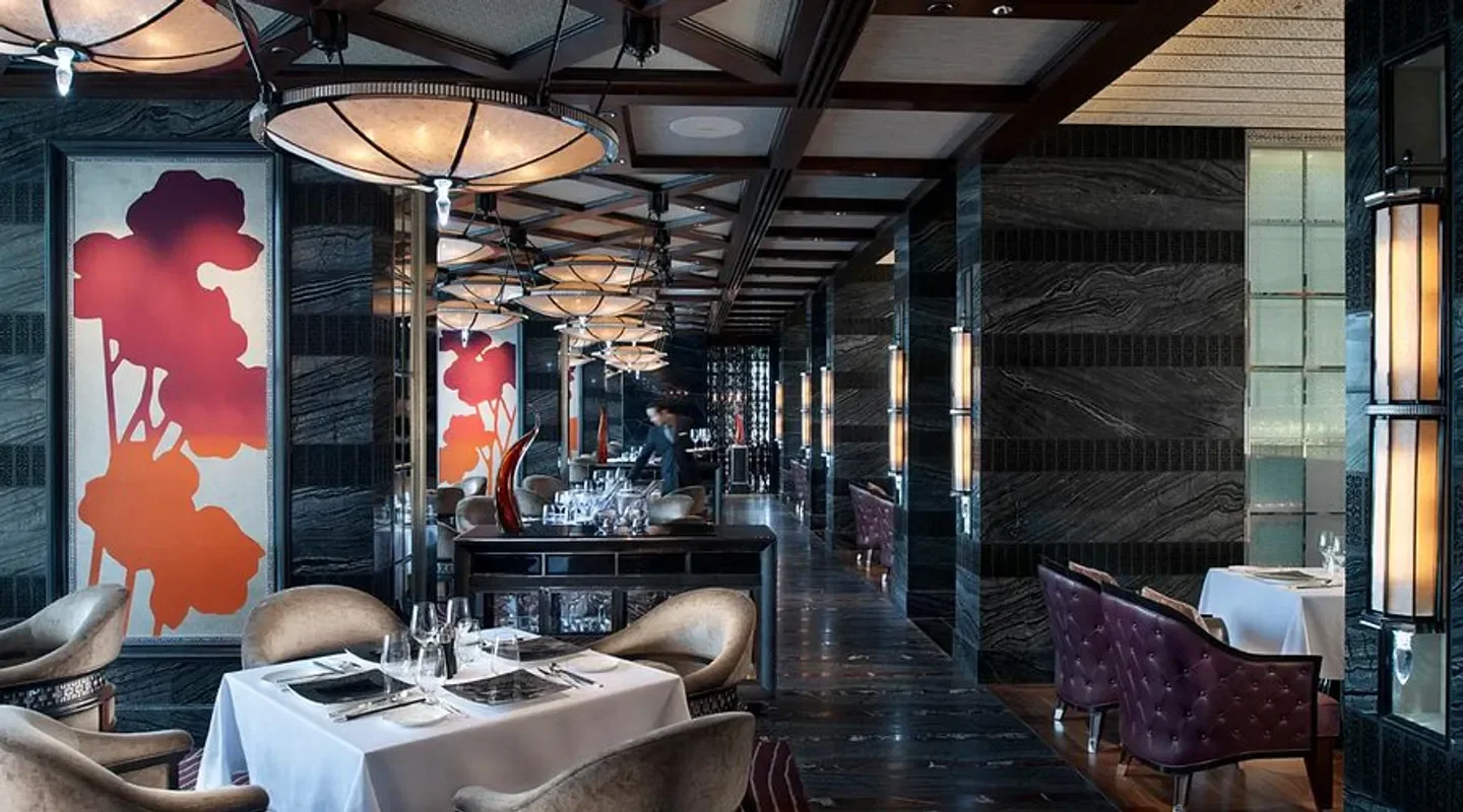 Elegant dining area at Vida Rica Restaurant in Macau, with modern decor and art.