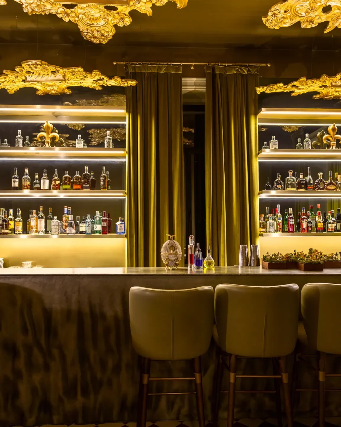 Interior bar at Vila Foz restaurant in Porto, showcasing elegant design and stocked shelves.