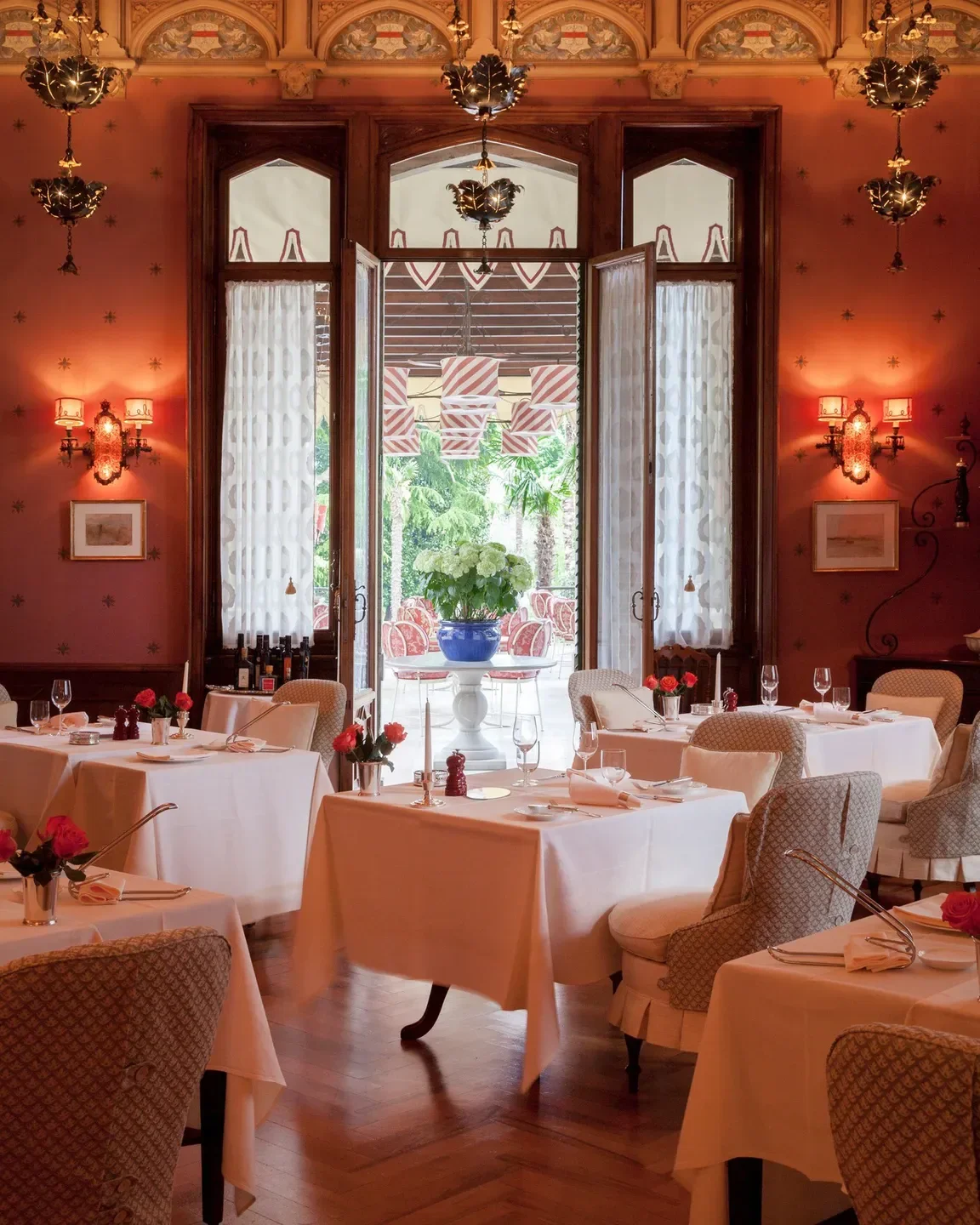 Elegant dining room interior at Villa Feltrinelli restaurant, Lago di Garda, Italy.
