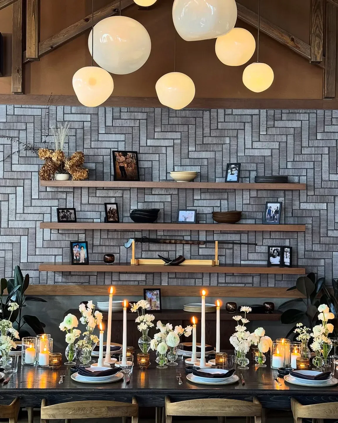 Vinai Minneapolis restaurant's candlelit dining table, elegant decor with floral arrangements.