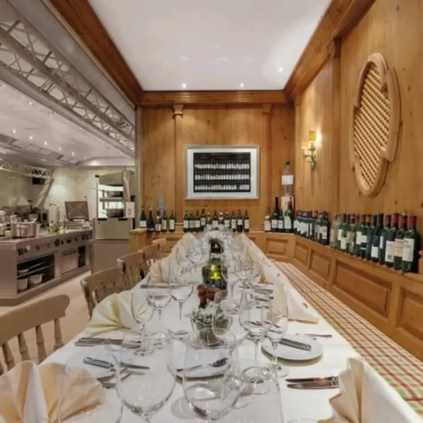 Vinothek by Geisel in Munich: elegant dining room with long table and wine selection.