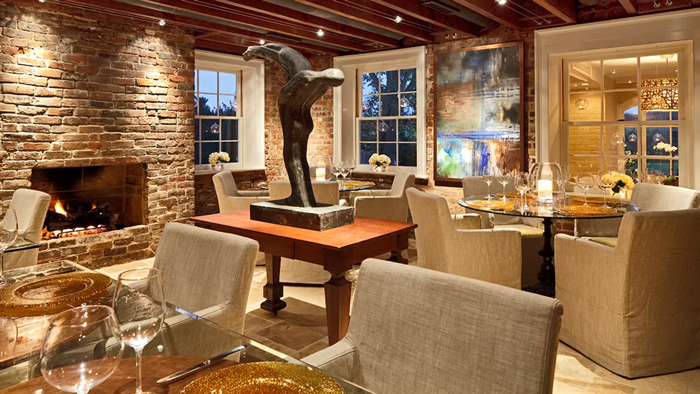 Cozy dining area at Vintage Restaurant in Orange County with a fireplace and sculpture.