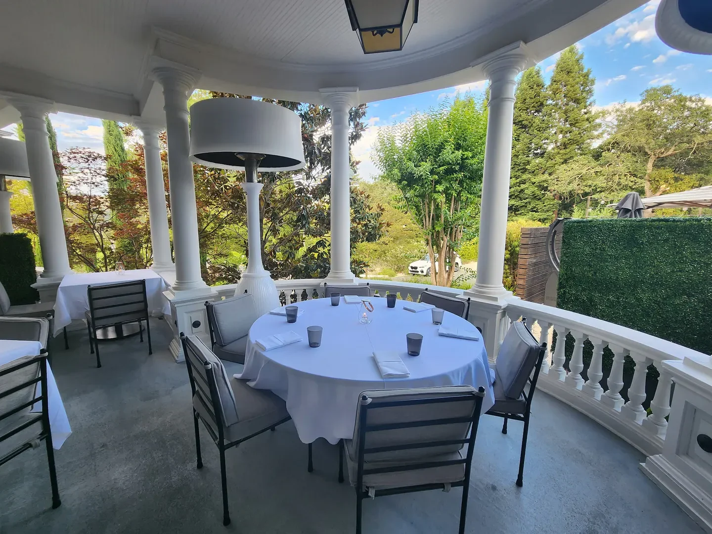 Outdoor dining at Violetto restaurant in Napa Valley with elegant tables and views
