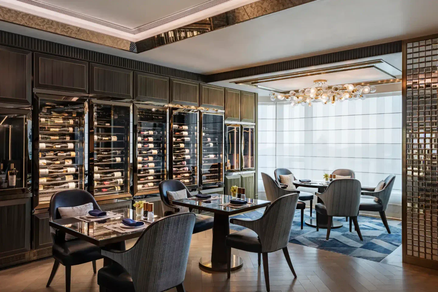 Elegant dining area at Vista 38 restaurant in Macau, showcasing wine storage and modern design