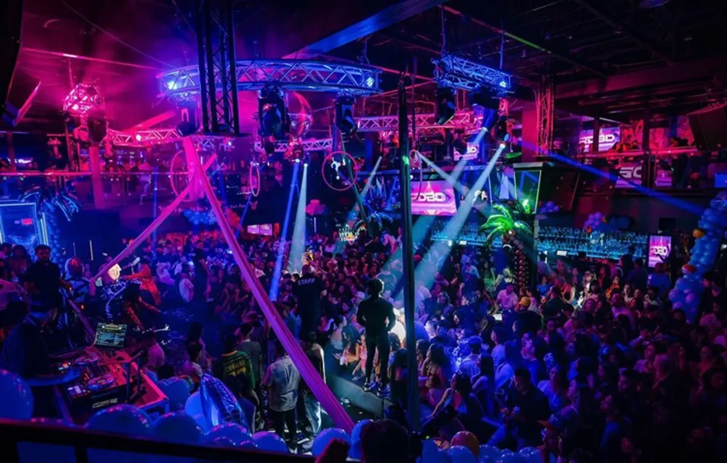 Energetic nightclub scene at Vivo in Dallas, featuring a packed dance floor and vibrant lights.