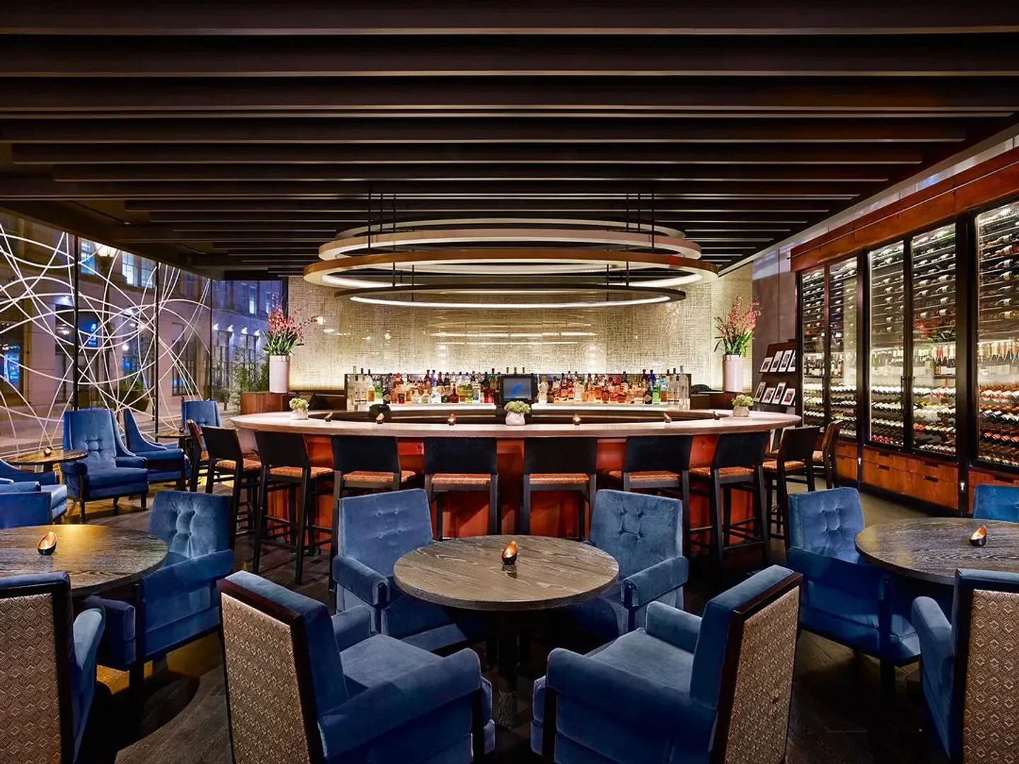 Interior view of the bar at Volver restaurant in Philadelphia, featuring blue chairs and stylish design