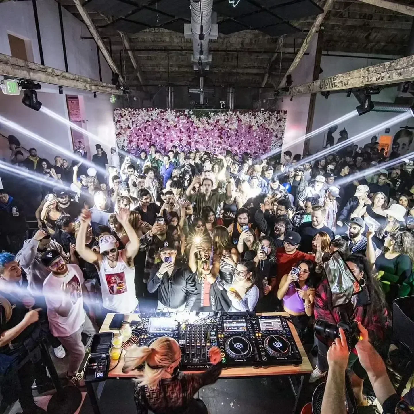 Energetic crowd at Vue nightclub in Seattle, with DJ at the center of the action.