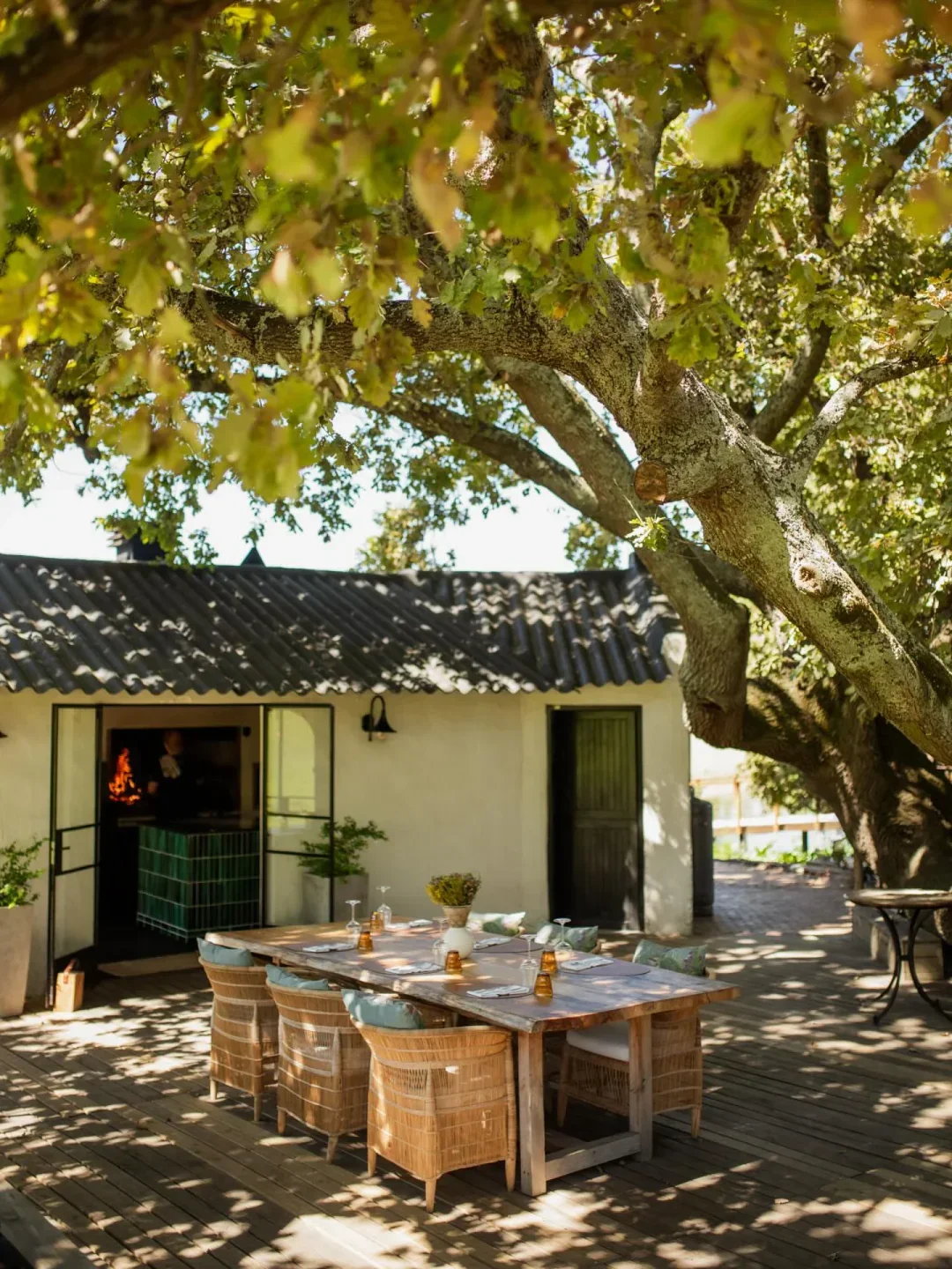 Outdoor dining at VUUR Restaurant at Remhoogte Wine Estate in Stellenbosch, South Africa.