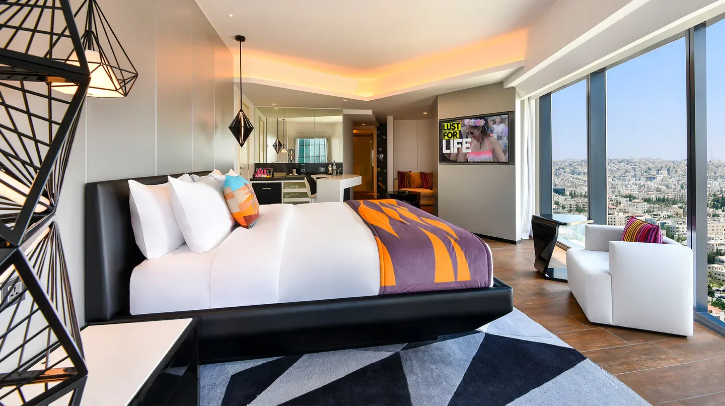 Modern bedroom with city views at W Amman in Amman, with stylish decor.