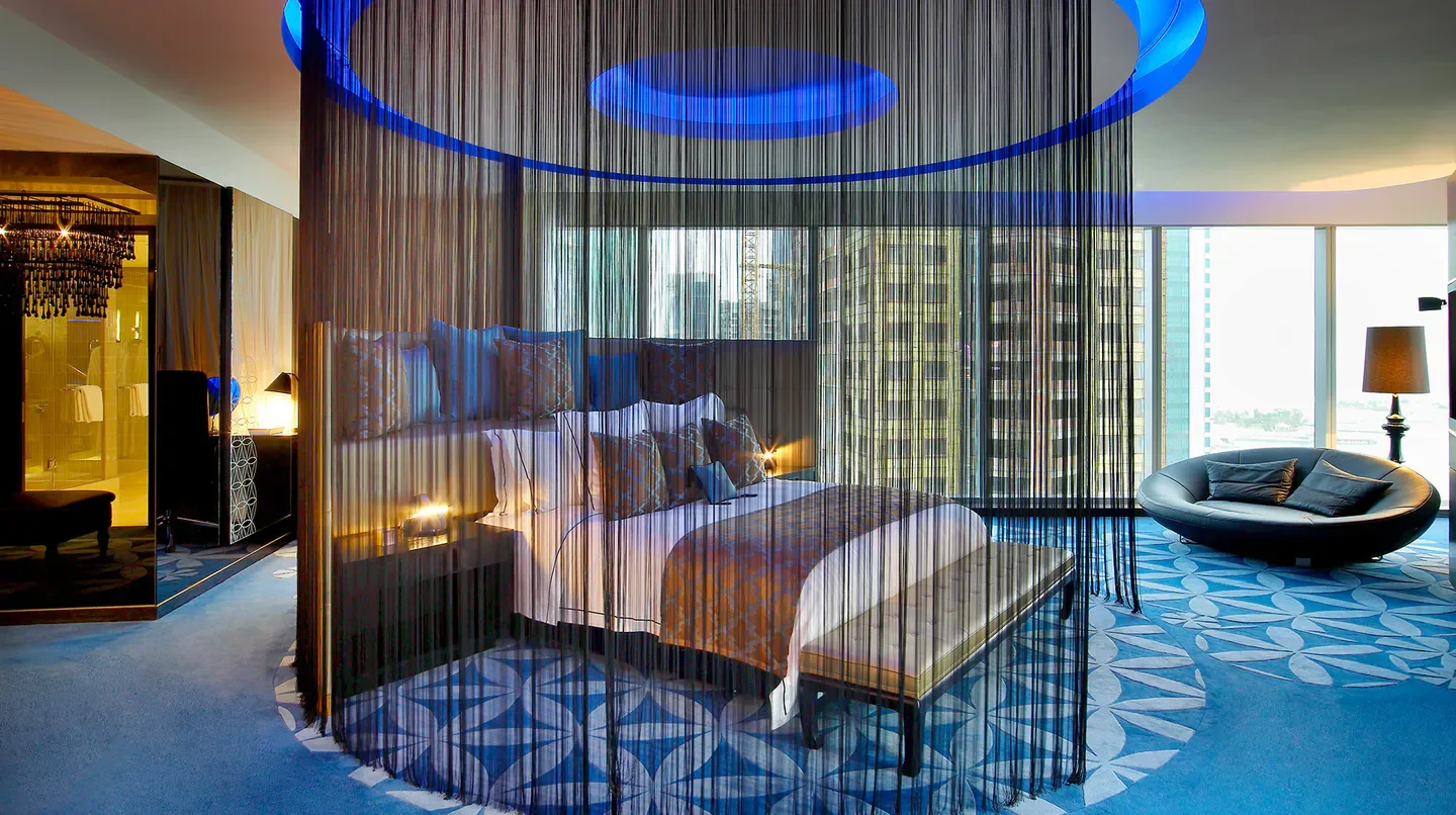 Stylish bedroom at W Doha Hotel & Residences in Doha, featuring modern design and city views.