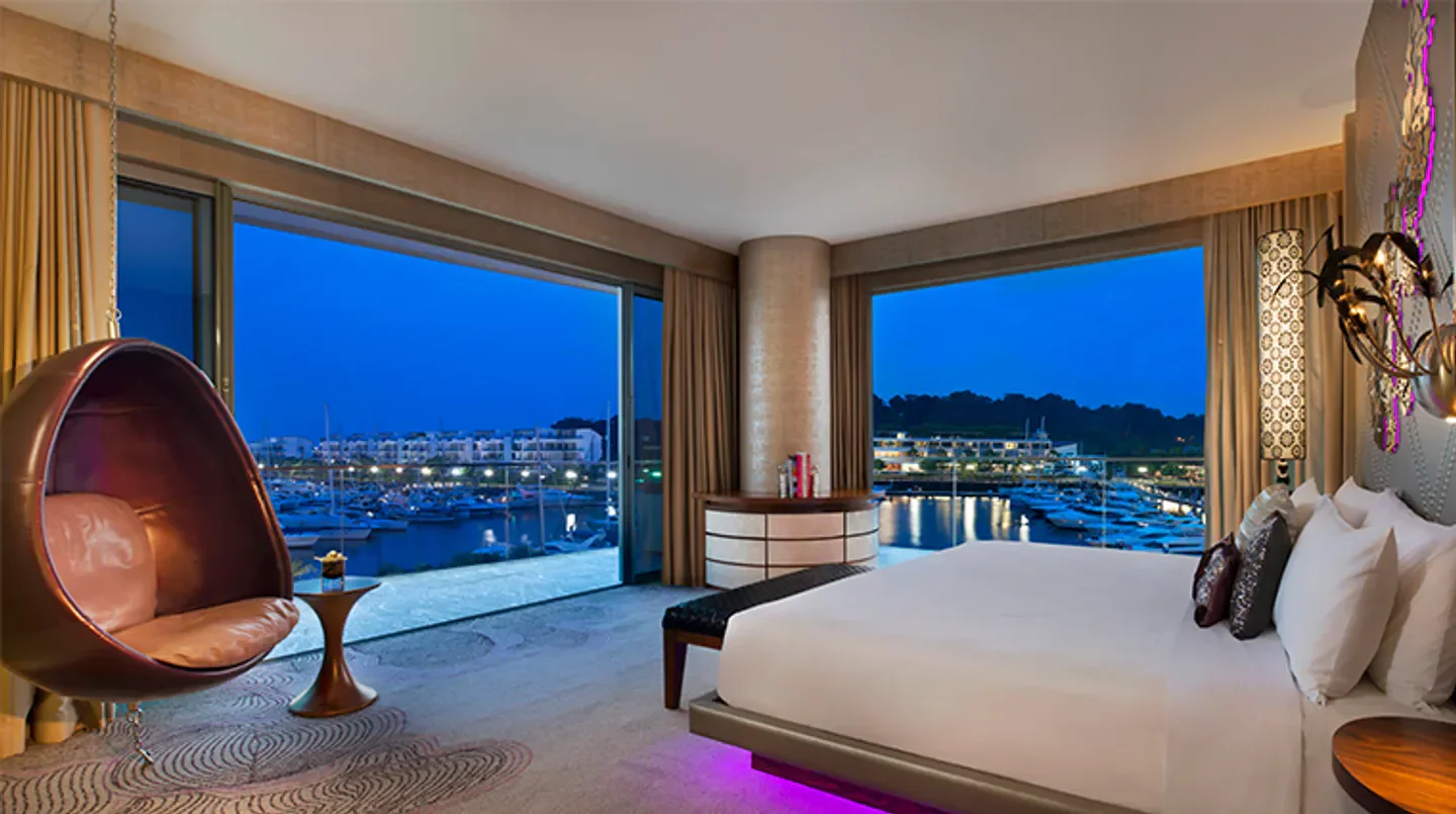 Luxury bedroom at W Singapore, Sentosa Cove with harbor view in Singapore.